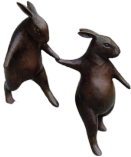 Statue of a rabbit holding the hand of another rabbit.